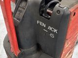 a red and black fork lifter sitting on the floor