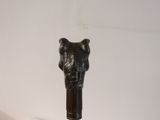 a black elephant head on top of a black cane