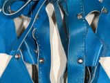 a mannequin with blue leather straps on a mannequin