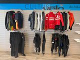a display of clothing hanging on a wall in a store