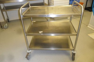 a metal cart with three shelves in a kitchen