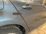 a close up of a car door handle with a sticker on it