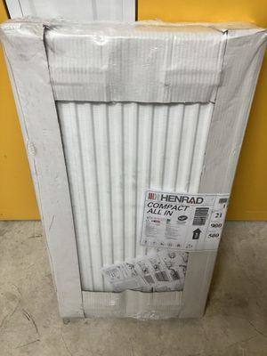 a box with a pair of shoes on top of it in front of a yellow wall