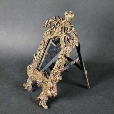 a small mirror on a stand with a mirror in it