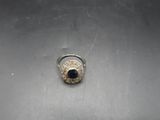 a silver ring with a black stone on top of it