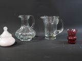 three glass vases sitting next to each other on a table