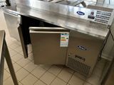 stainless steel counter top in a commercial kitchen with two sinks