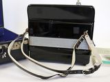 a black suitcase with a silver handle and a black strap
