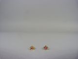 a pair of pink and yellow earrings on a white surface