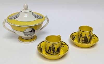 three pieces of yellow and white porcelain tea set on a white surface