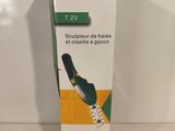 box of toothbrushes sitting on a white surface with a green and yellow stripe
