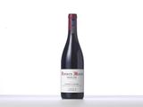 a bottle of red wine sitting on top of a counter