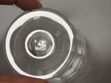 a person holding a clear glass with a light inside of it