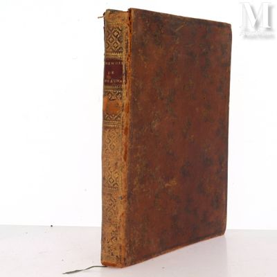 an old book sitting on top of a table next to a white wall