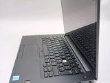 a laptop computer sitting open on a white surface