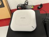 a close up of a white zyxel router sitting on top of a table