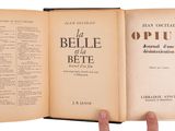 someone is holding an open book in their hand on a white background