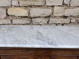 a marble top table with a drawer underneath it