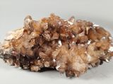a cluster of brown crystals on a white surface