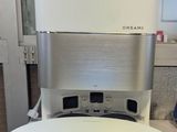 a white speaker sitting on top of a white table