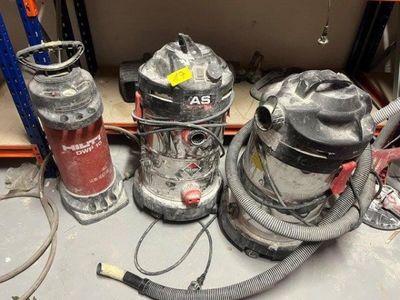 several vacuums are sitting on a table in a room