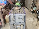 a machine that is sitting in a garage with a hose