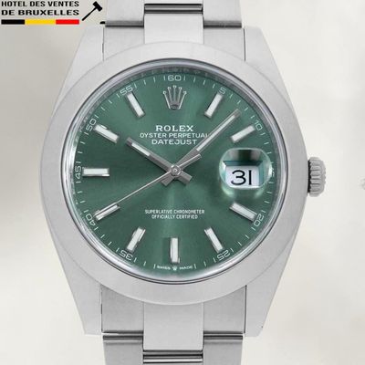 a rolex watch with a green dial on a bracelet