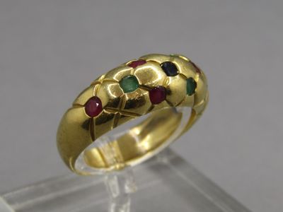 a close up of a gold ring with multi colored stones on it