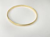 a close up of a gold ring on a white surface
