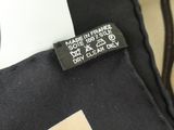 the label on the back of a black and white jacket
