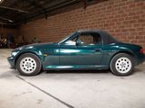 an image of a green sports car parked in a garage