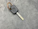 a car key that is laying on a metal surface