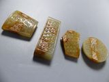 three pieces of carved soap sitting next to each other on a table