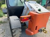 a tractor that is parked on the side of the road