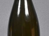 a bottle with a label on it sitting on a table
