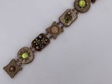 a close up of a bracelet on a white surface