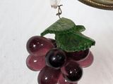 a close up of a pair of grapes hanging from a hook