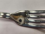 a fork with a hole in the middle of it