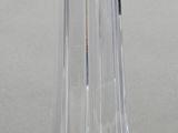 a clear glass vase with a silver base on a table