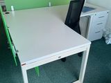 un bureau blanc avec des séparateurs verts et une chaise noire
