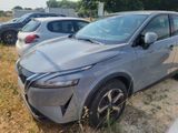 a silver car that is parked on the side of the road