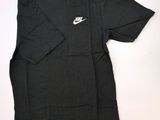 the shirt is black and has a white nike logo on it