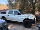 a white truck that is parked in the dirt