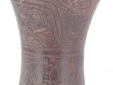 a brown vase sitting on a white surface
