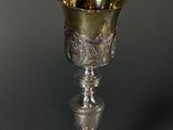 an antique silver goblet sitting on top of a table