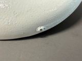 a close up of a white object on a table