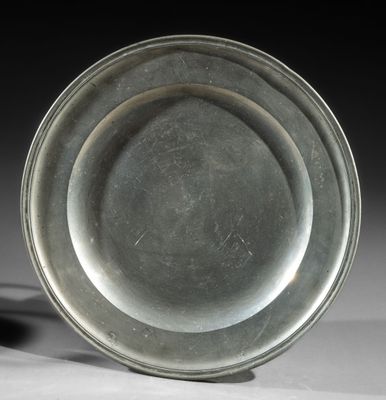 a silver plate sitting on top of a white table