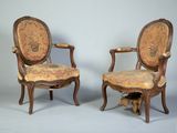 pair of louis xvi style carved walnut armchairs with upholstered upholstered seats