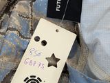 a label on the back of a jacket with a star on it