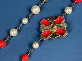 a close up of a rosary on a blue surface